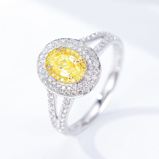 Oval Cut Yellow Diamond Engagement Ring with Pavé Halo Setting in 18K White Gold