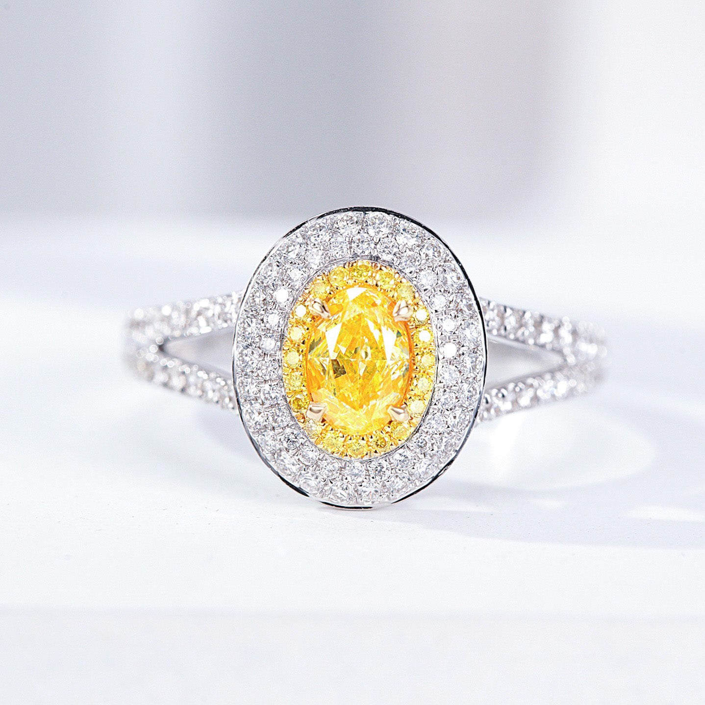 Oval Cut Yellow Diamond Engagement Ring with Pavé Halo Setting in 18K White Gold -Front View