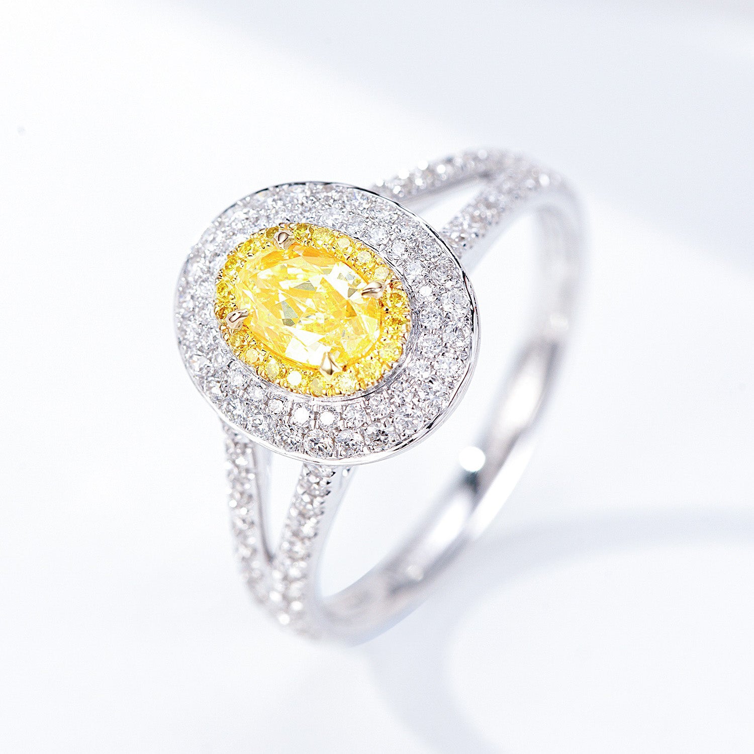 Oval Cut Yellow Diamond Engagement Ring with Pavé Halo Setting in 18K White Gold -Side Angle