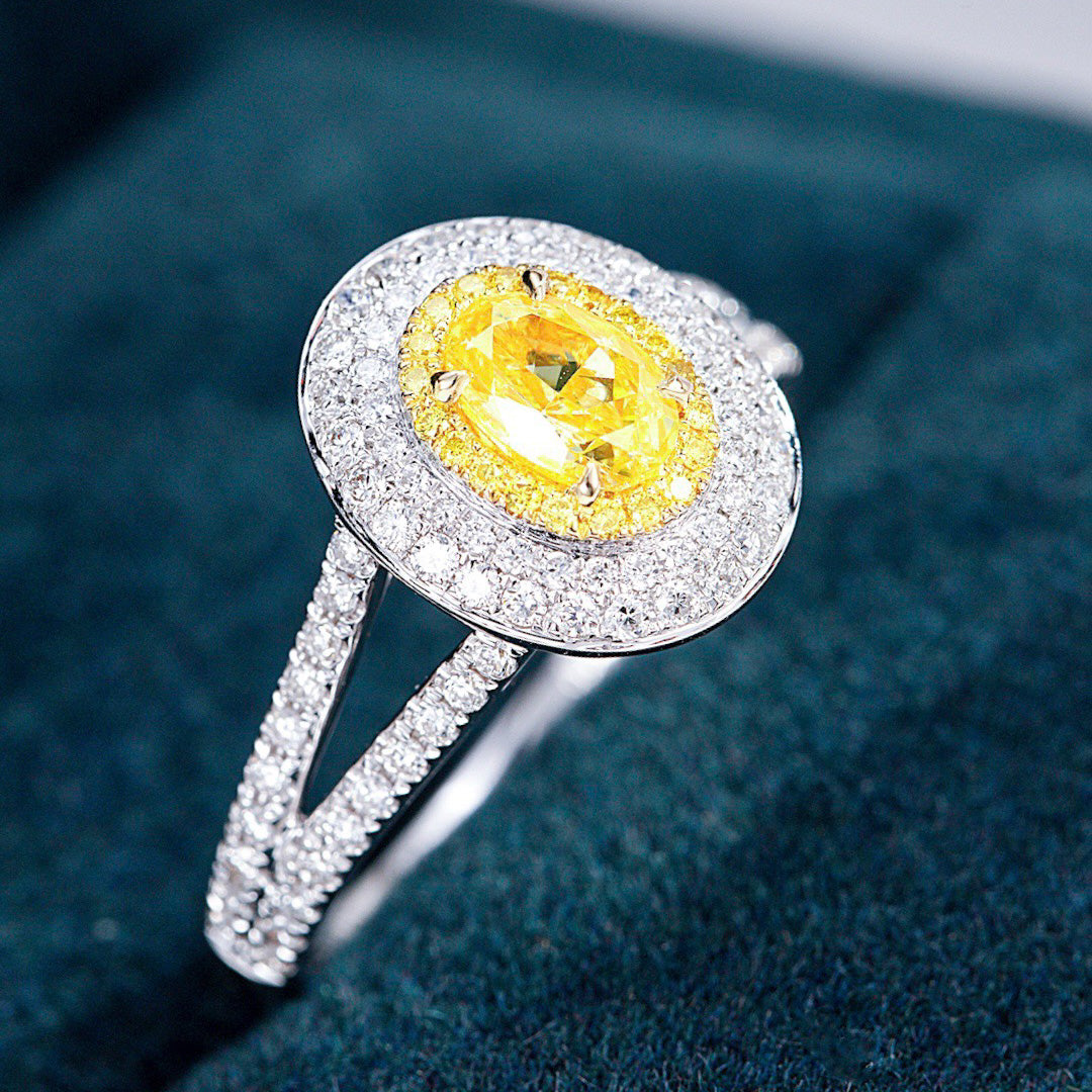 Oval Cut Yellow Diamond Engagement Ring with Pavé Halo Setting in 18K White Gold -Perspective Close-up