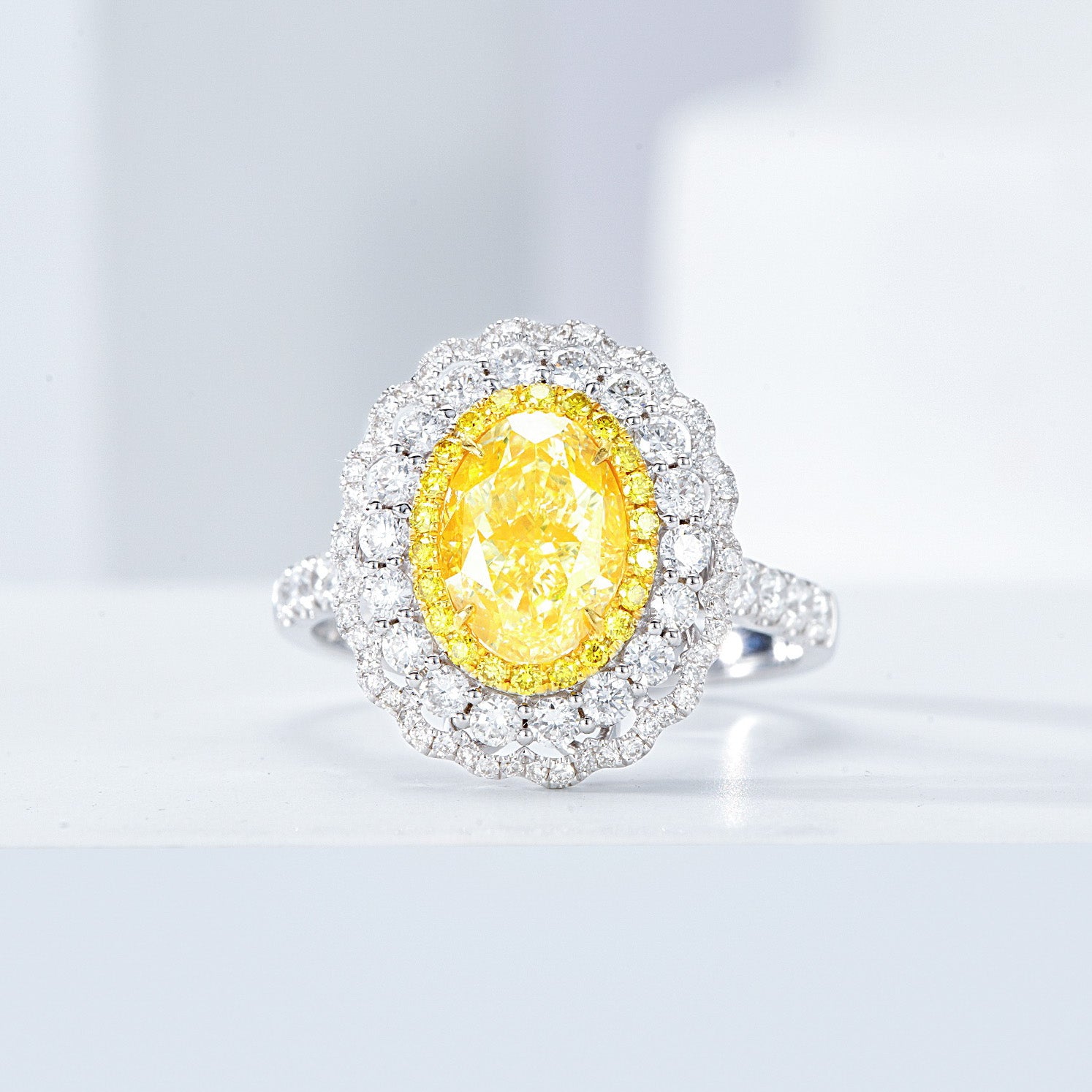 Oval Cut Yellow Diamond Engagement Ring with Pavé Halo Setting in 18K White Gold -Front View