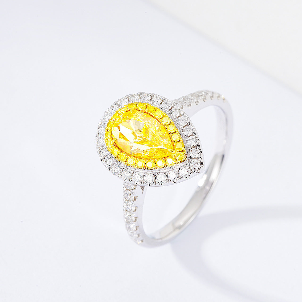 Pear Shaped Yellow Diamond Engagement Ring with Pavé Halo Setting in White Gold -Side Angle