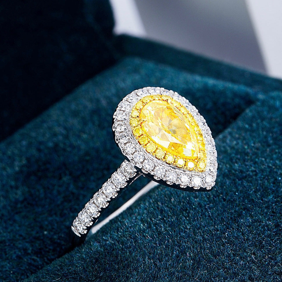 Pear Shaped Yellow Diamond Engagement Ring with Pavé Halo Setting in White Gold -Perspective Close-up