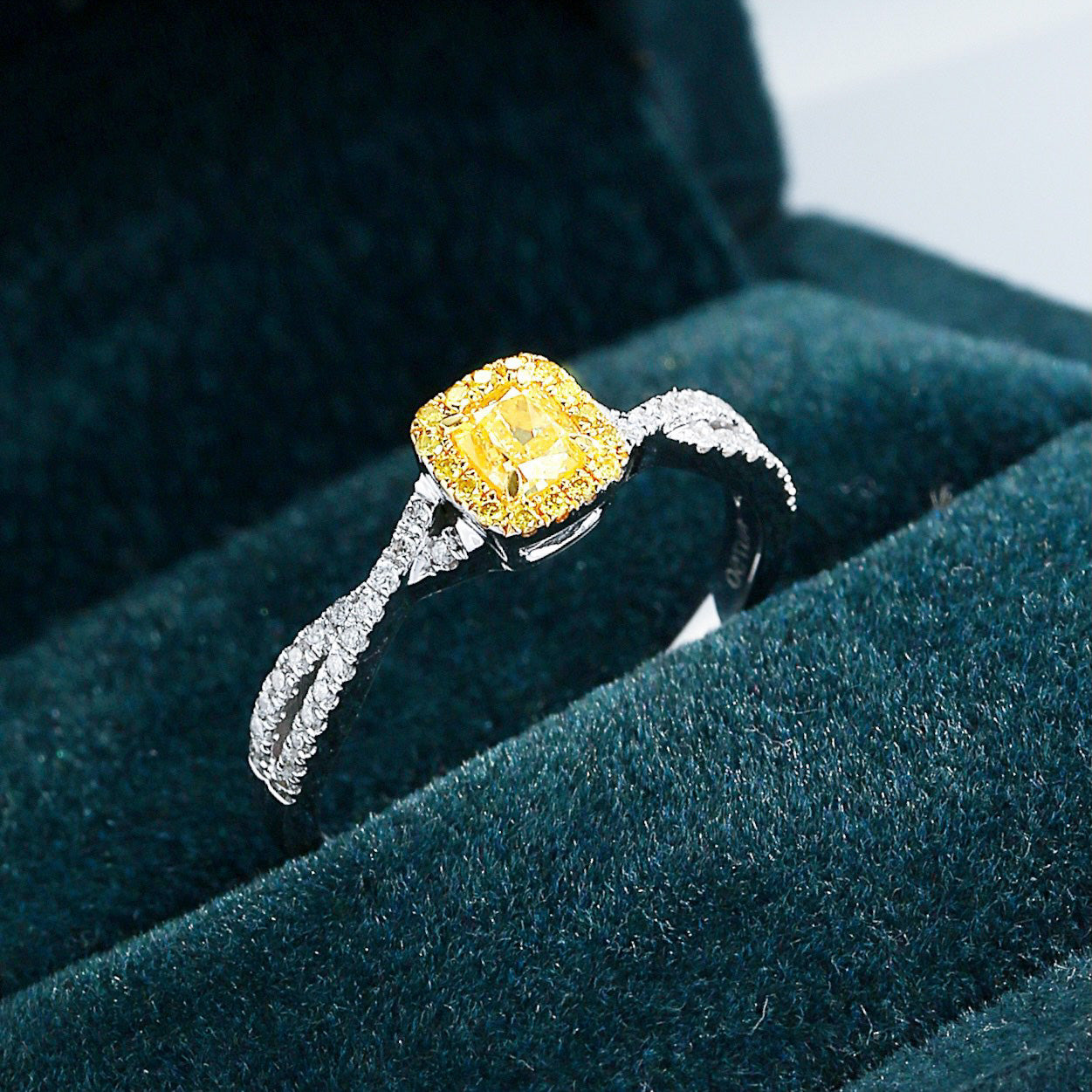 Elegant Cushion Cut Yellow Diamond Ring with Twisted Band Design -Perspective Close-up