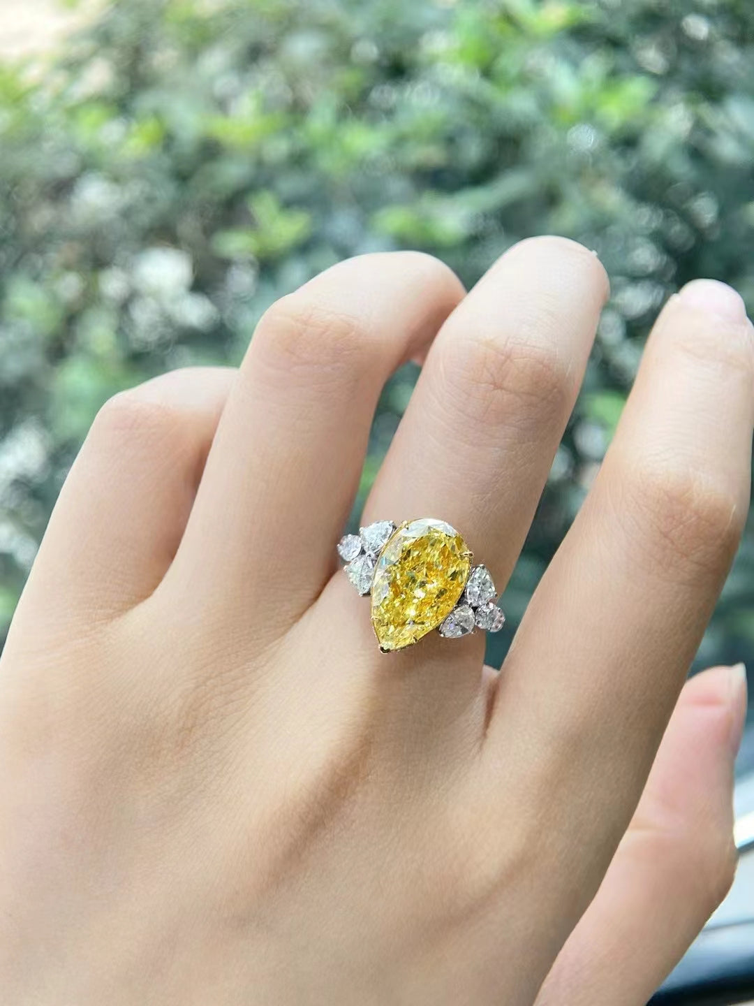 Fingers with yellow diamonds ring