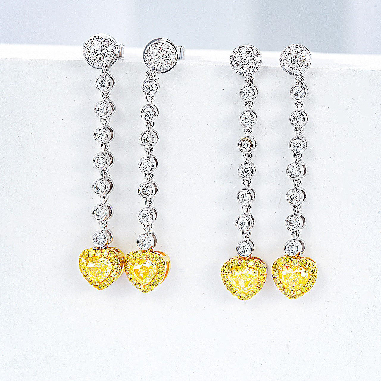 Heart Shaped Yellow Diamond Journey Earrings in White Gold -Perspective Close-up