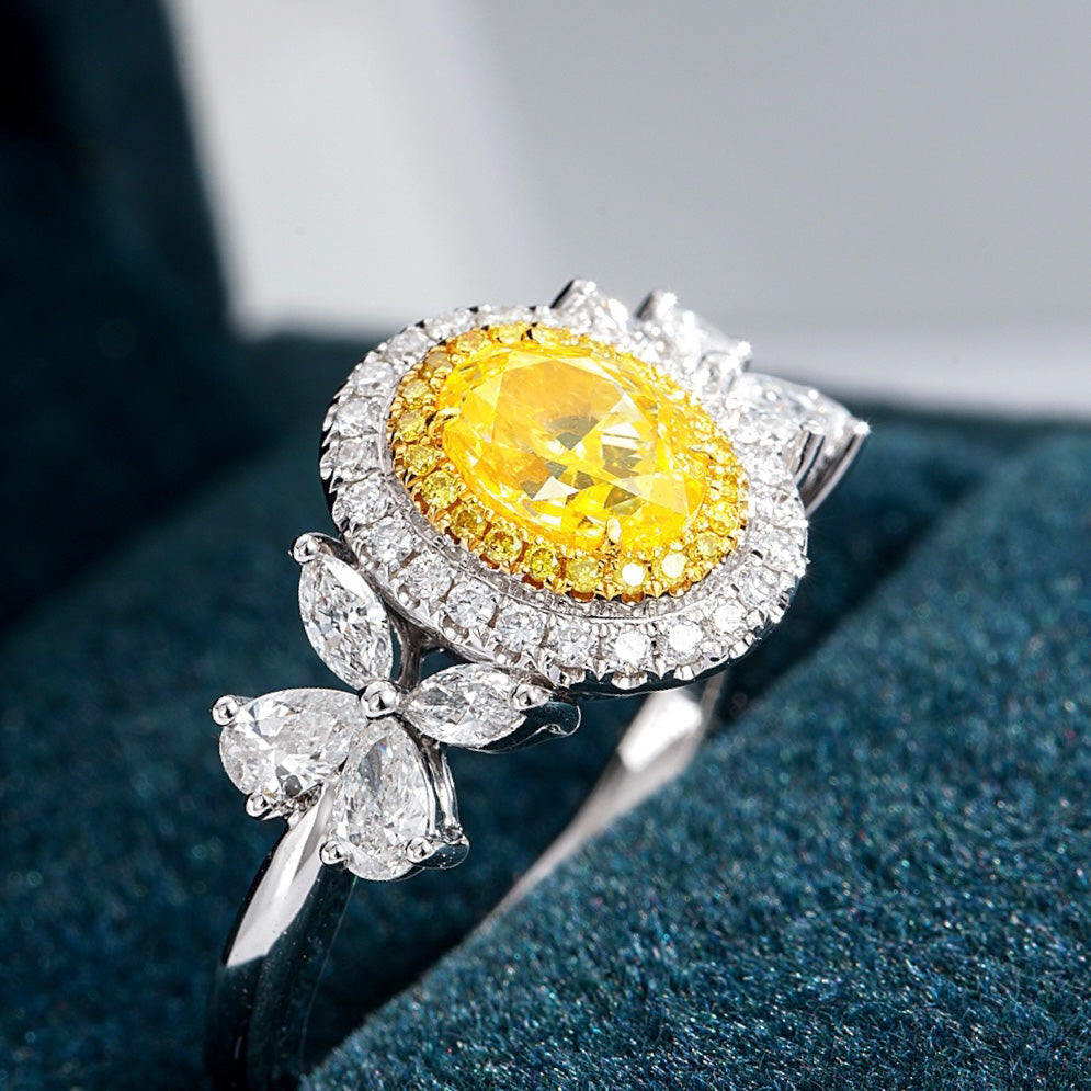 Oval Cut Yellow Diamond Halo Engagement Ring with Pear & Marquise Shaped Side Stones in 18K White Gold -Perspective Close-up